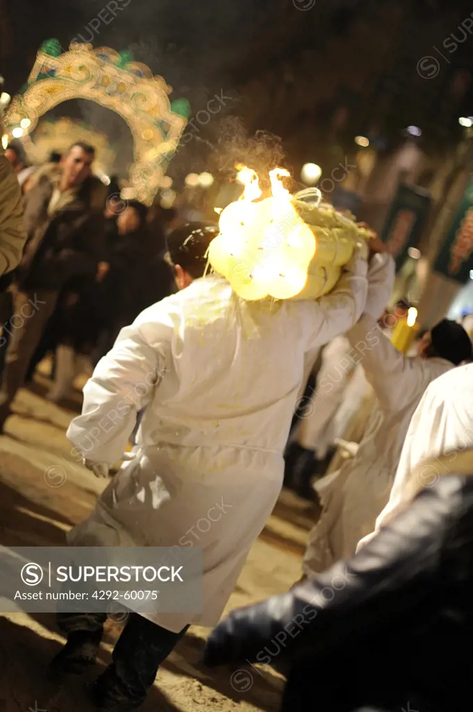 Italy, Sicily, Catania, man carrying candle during Sant'Agata Feast (the Patron Saint of the city)