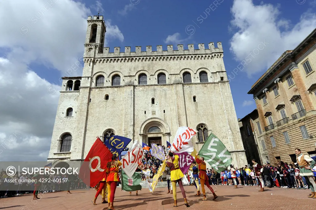 Italy, Umbria, Gubbio, Flag wave background Palazzo dei Consoli