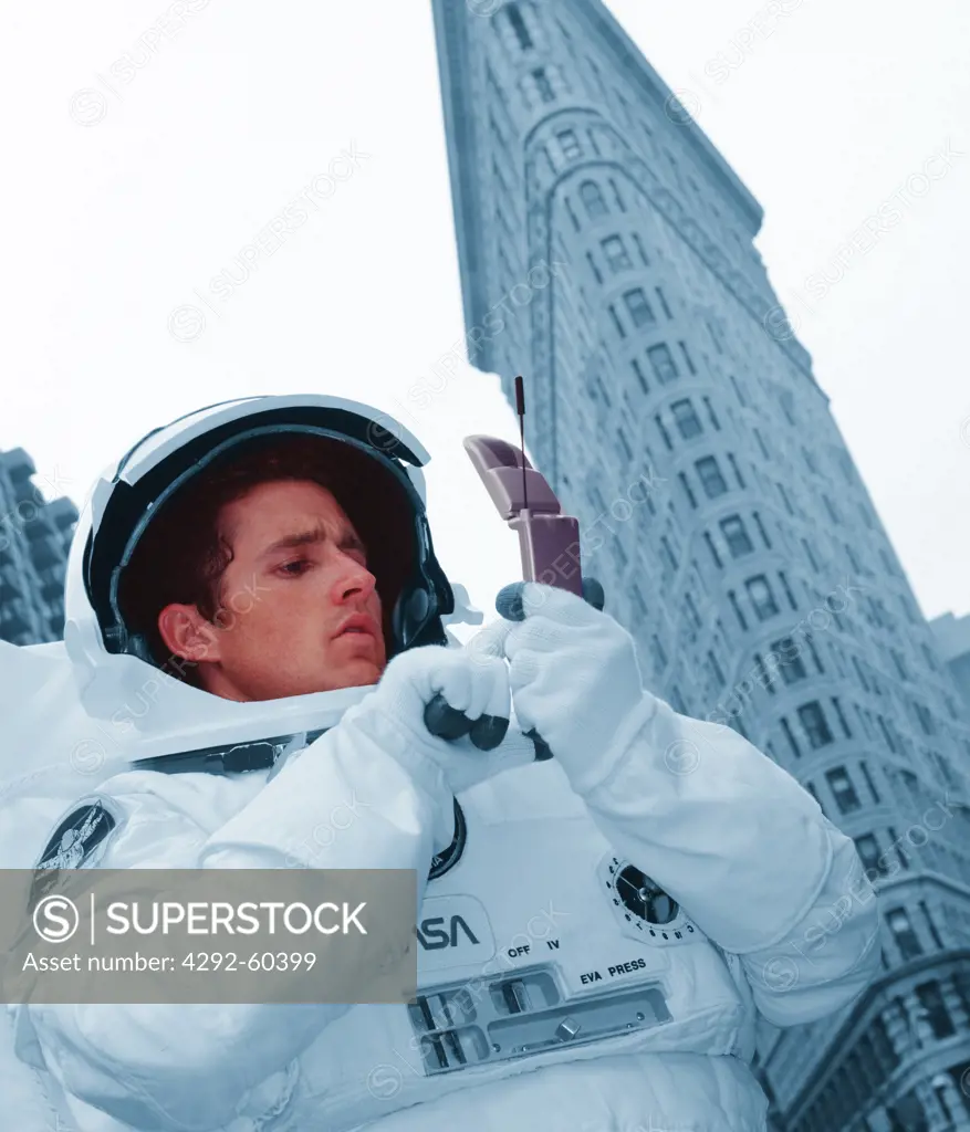 USA, New York, Spaceman with mobile phone (digital composite)