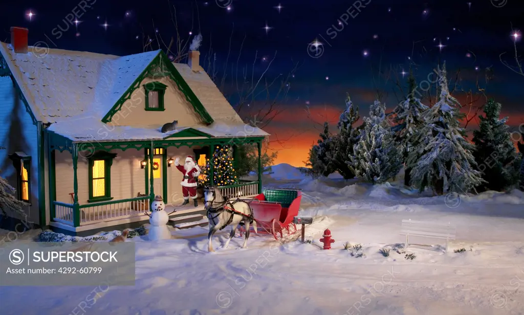 Santa Clus standing by house door