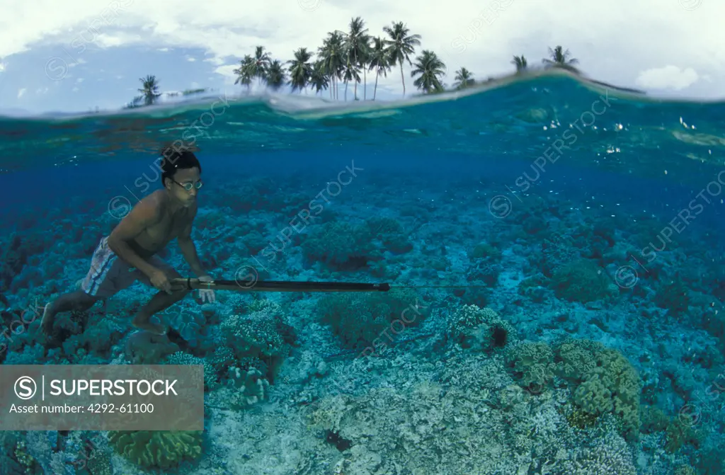 Fisherman with spear gun. Bunaken, Sulawesi, Indonesia