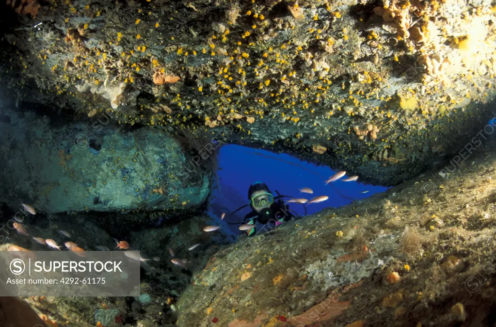 Italy, Aeolian Islands, Lipari, diver exploring underwater cave