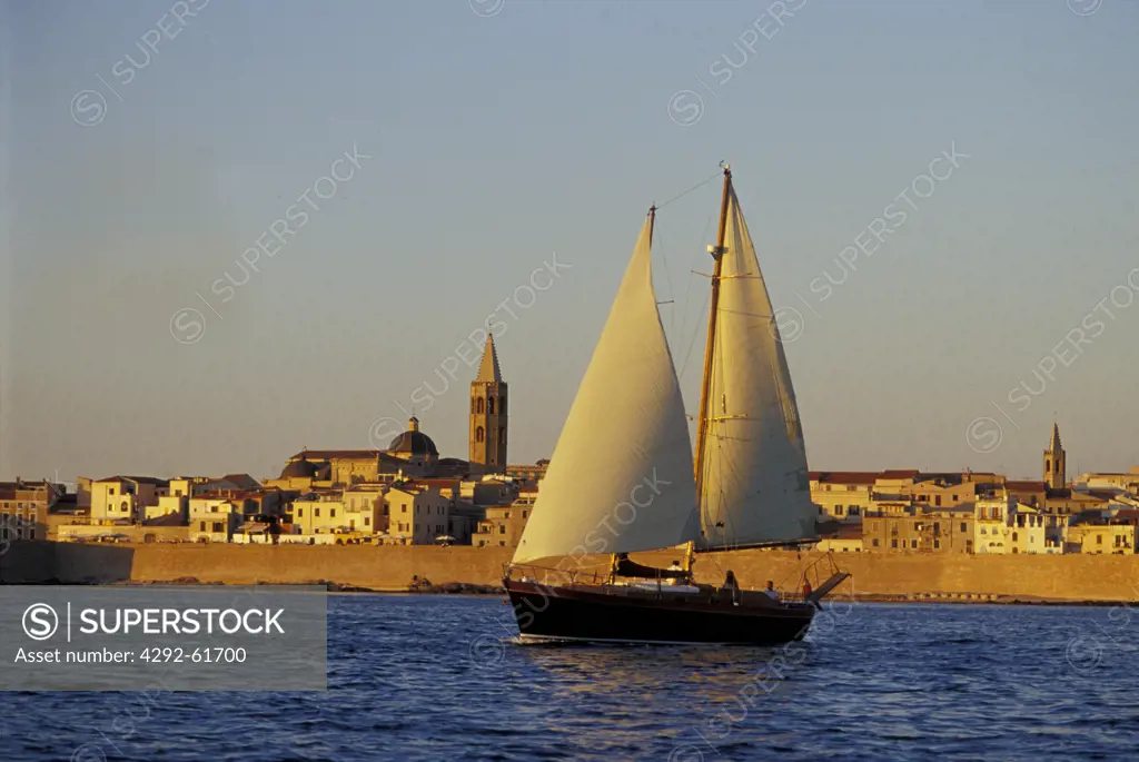 Italy, Sardinia, Alghero, sailboat at sunset