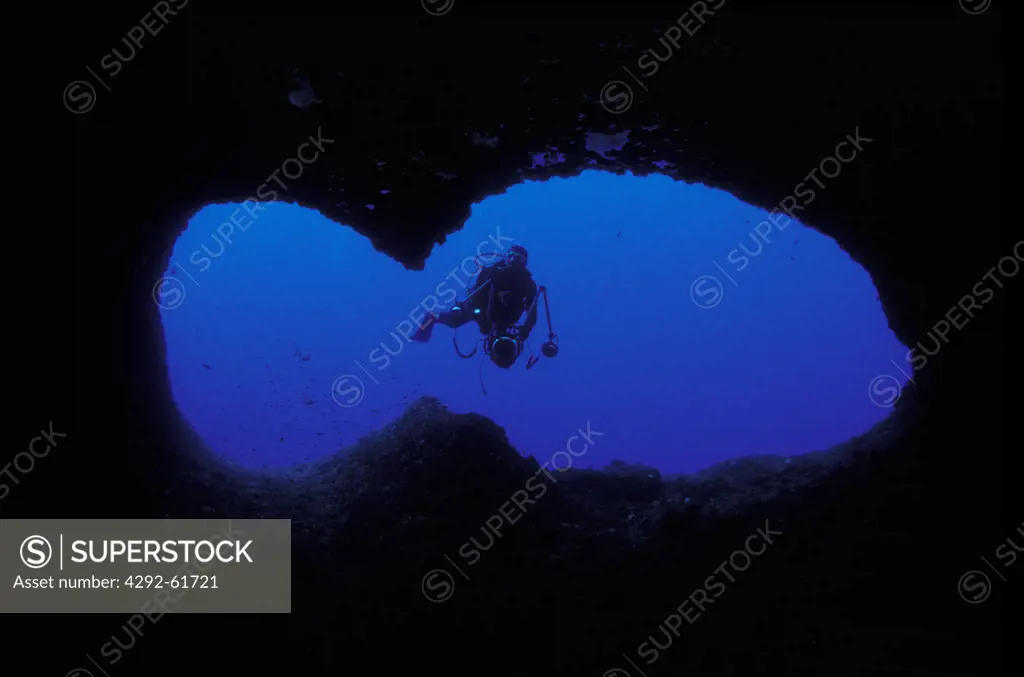 Italy, Sardinia, diver exploring underwater Capo Caccia cave