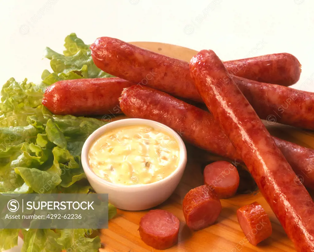 Sausages, white sauce and lettuce