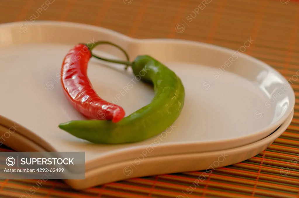 Two chili peppers on a heart-shaped plate