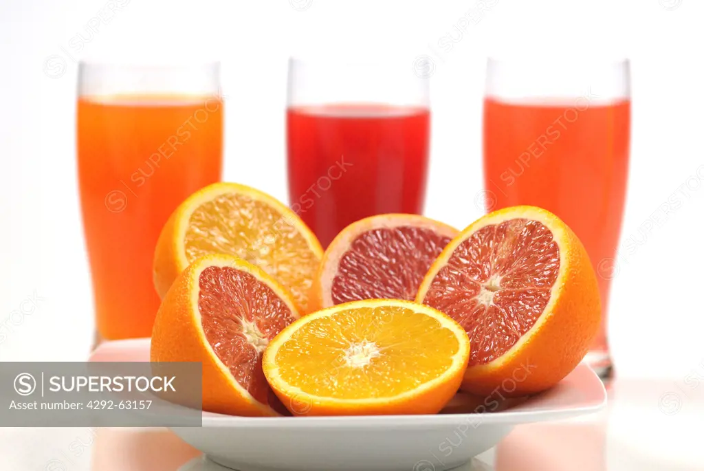 Fresh grapefruits, oranges and glass of juice