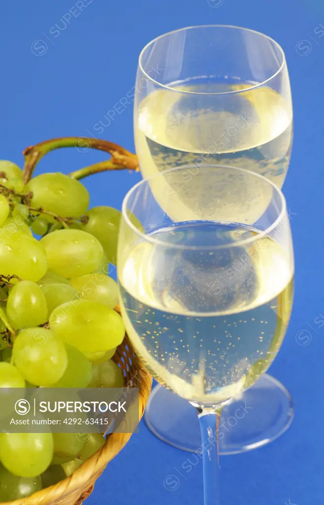 Glasses of white wine and grapes