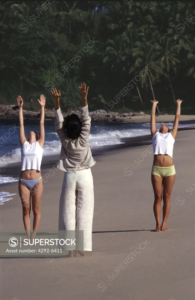 Women exercising on the beach. Phuket, Thailand