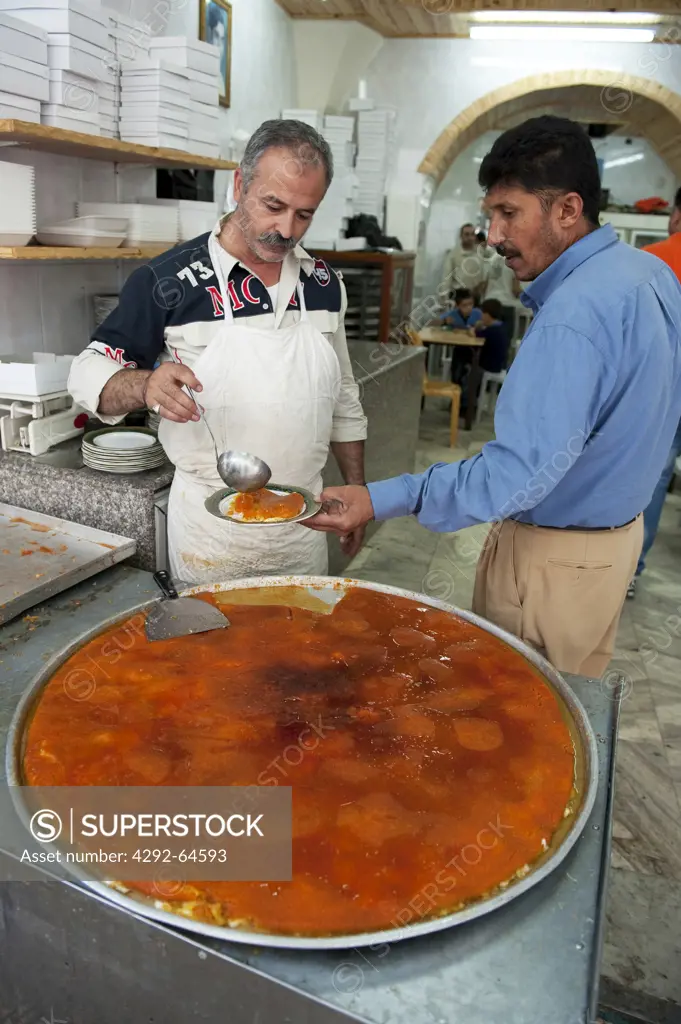 Israel, West Bank, Nablus, man cooking kunafeh