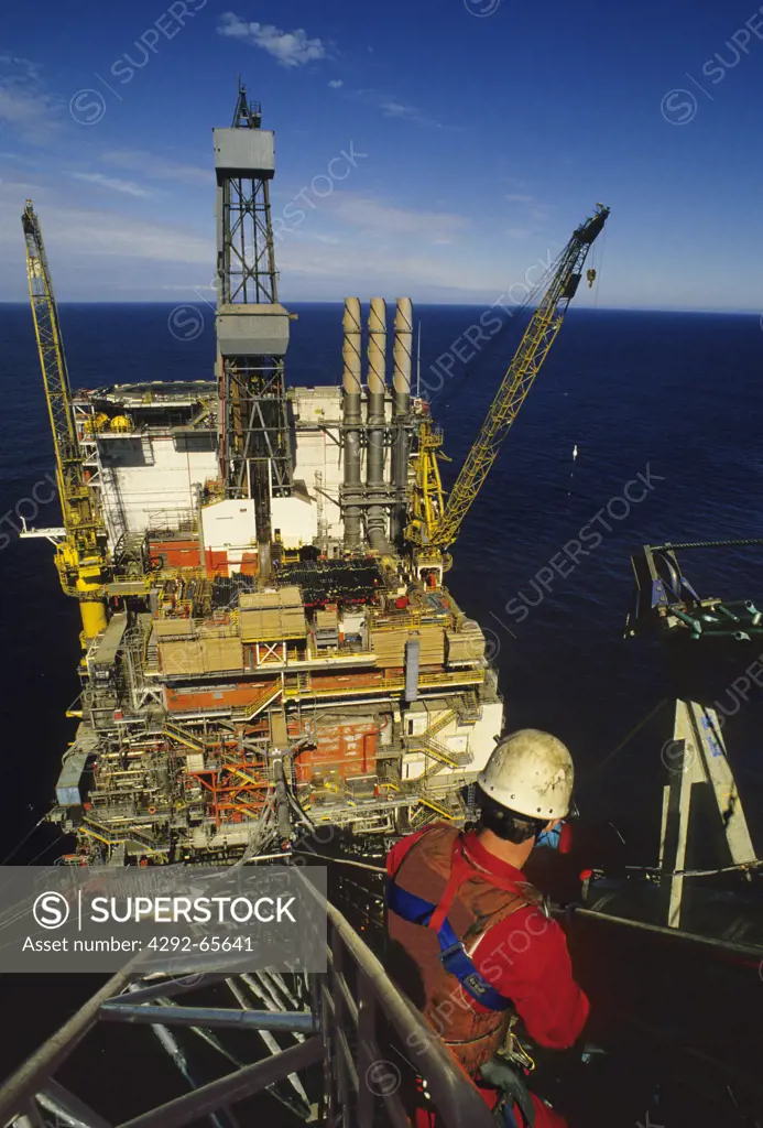 Offshore oil industry, Engineers working on the flare tip of an offshore oil production platform in the North Sea
