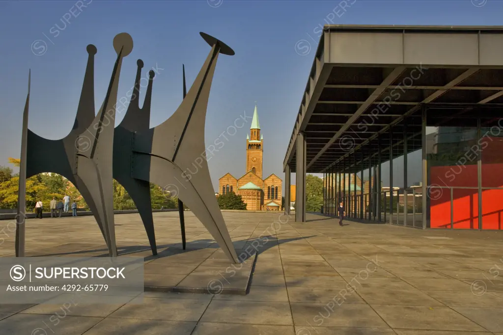 Berlin, Germany. Gallery of Modern Art, designed by Mies van der Rohe with the St. Matthaeus-kirche in the background. Calders sculpture ‘Tetes a Queue stands in the foreground
