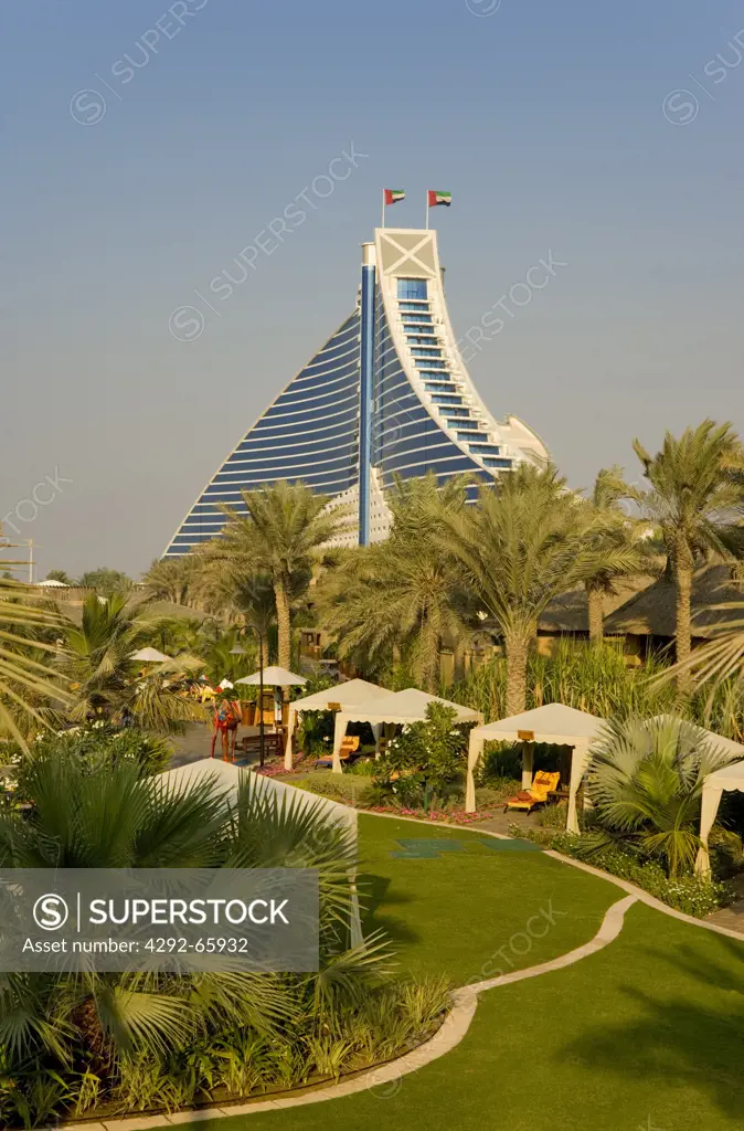 United Arab Emirates, Dubai, View of Jumeirah Beach Hotel over executive pool area, pavilions and gardens.