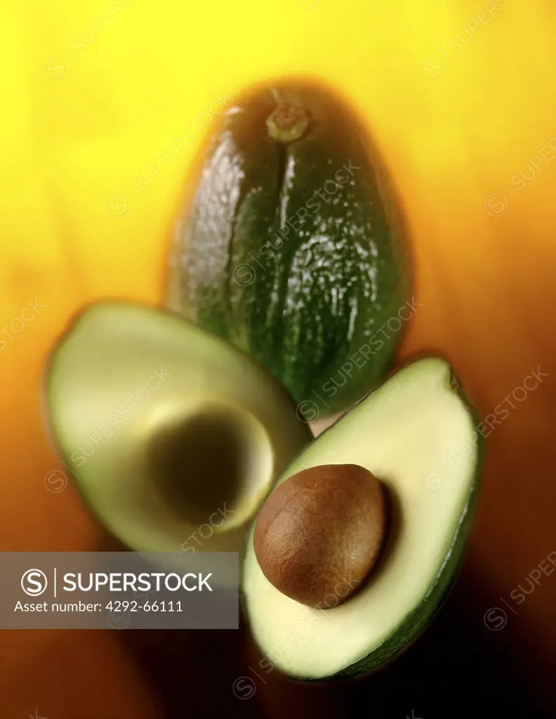 Avocados on yellow background