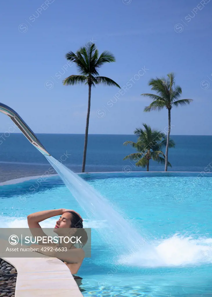 Girl bathing in pool of Sasha Resort in Koh Samui, Thailand