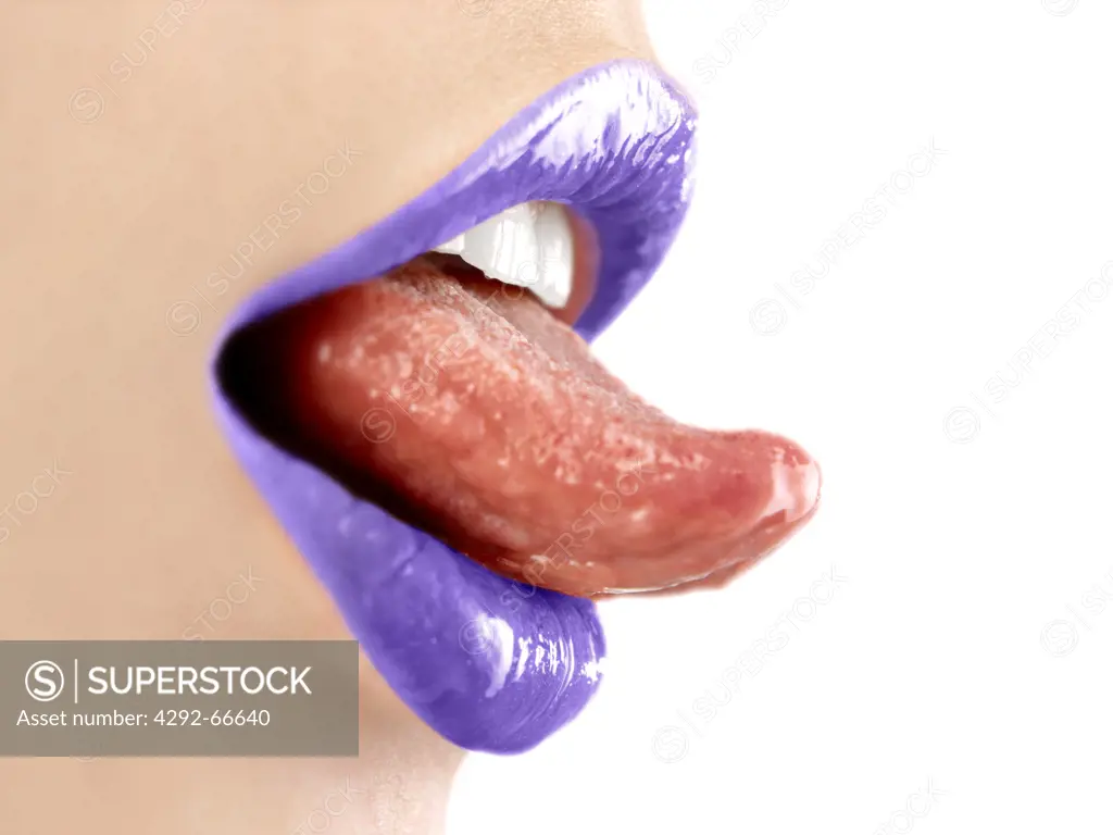 Close up of woman's mouth wearing purple lipstick