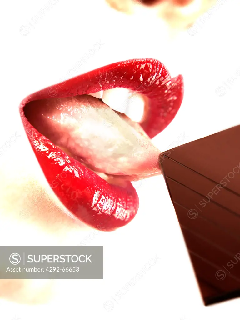 Woman's tongue licking chocolate