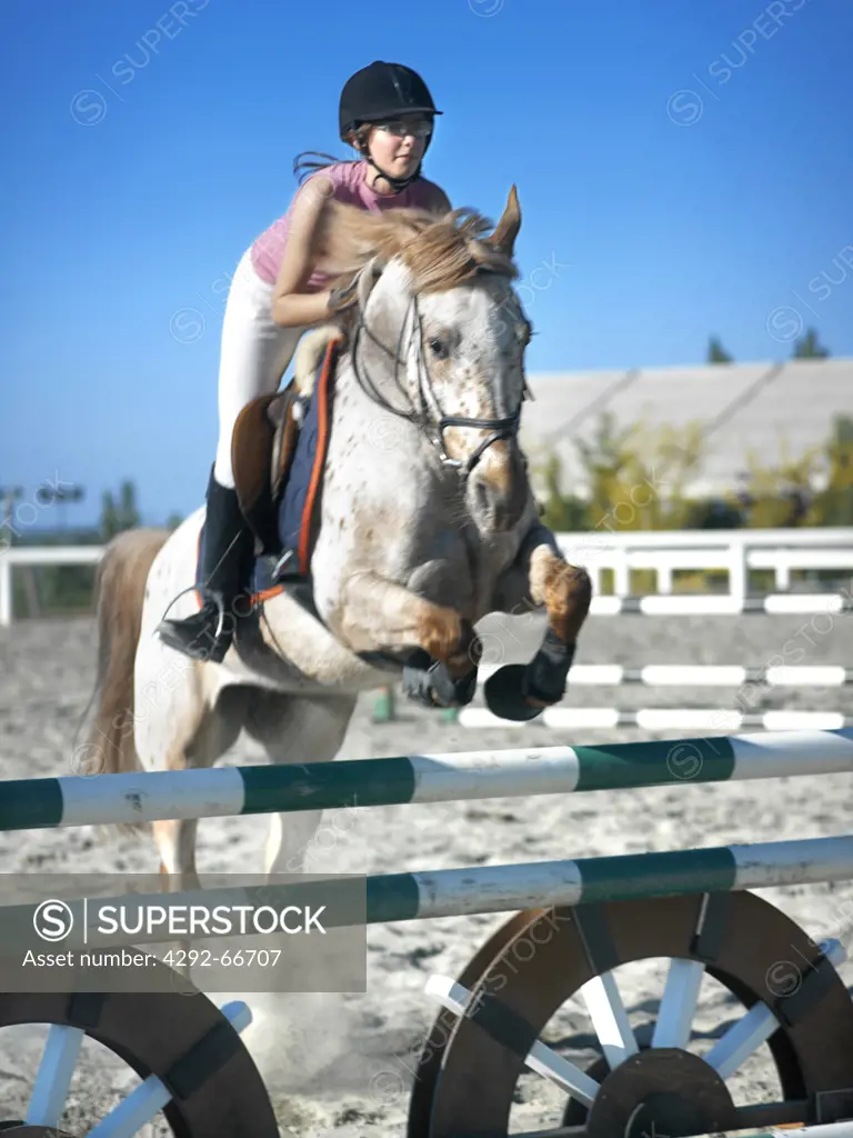 Teenager horse jumping