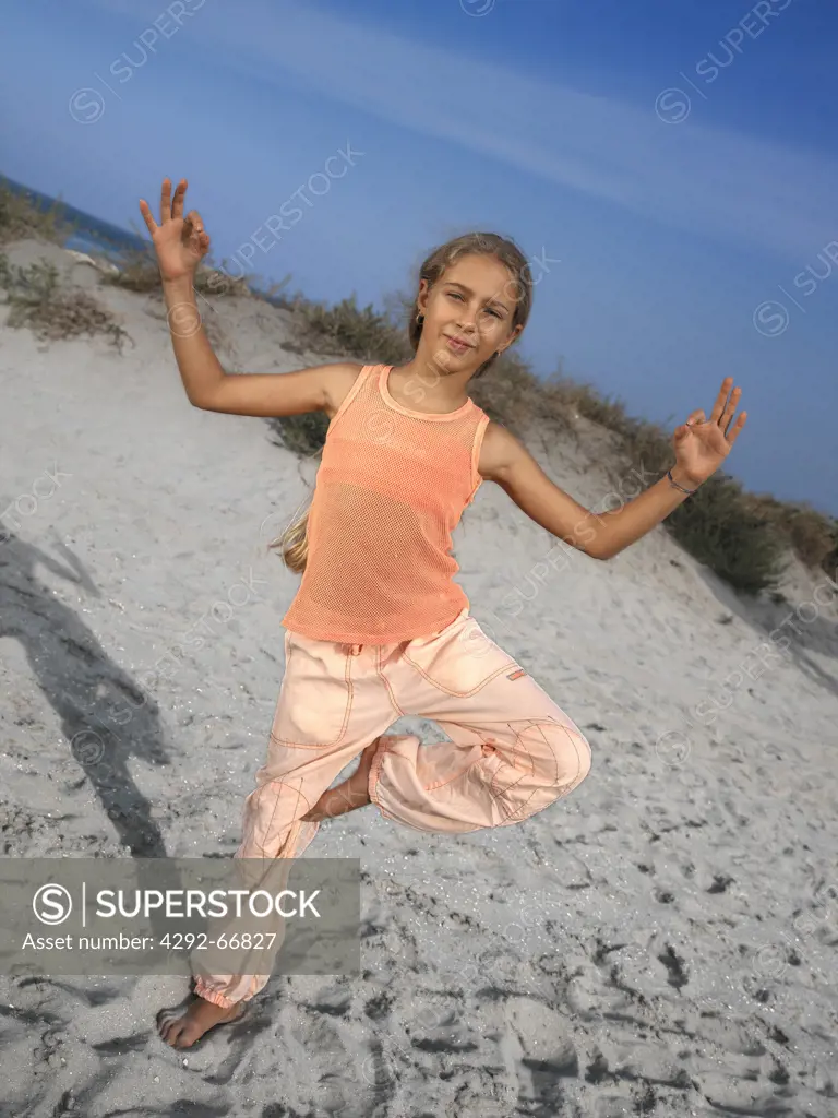 Girl doing yoga on beach