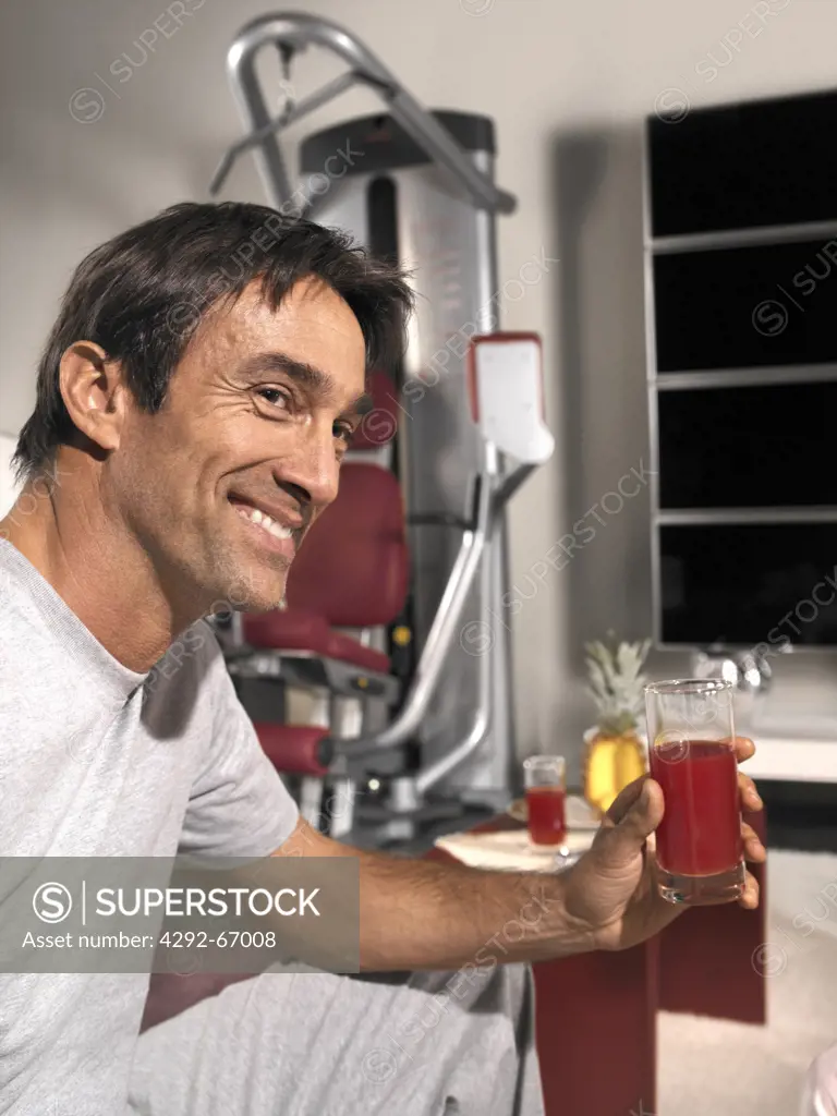 Man having a glass of orange juice after working out