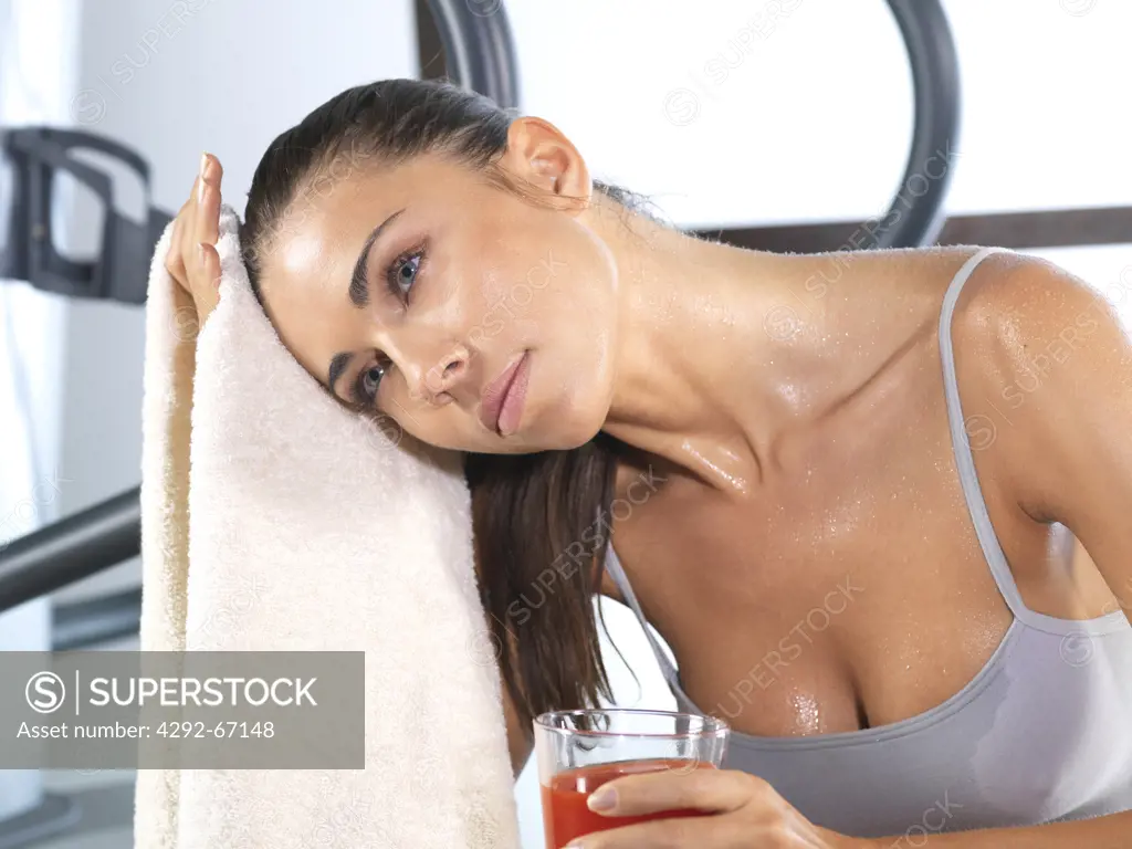 Woman relaxing after working out in gym