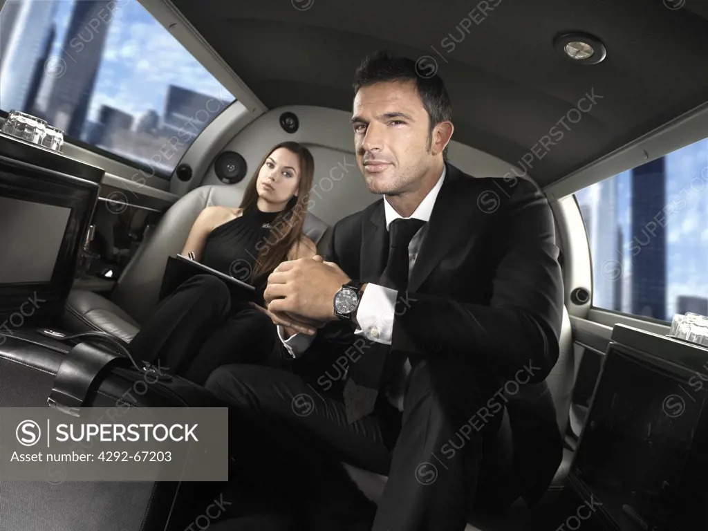 Businessman with secretary in limousine