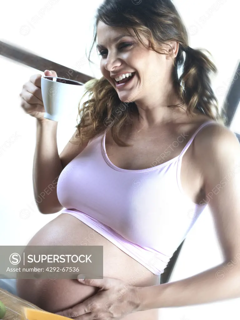 Pregnant woman with cup
