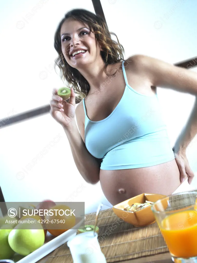Pregnant woman having breakfast