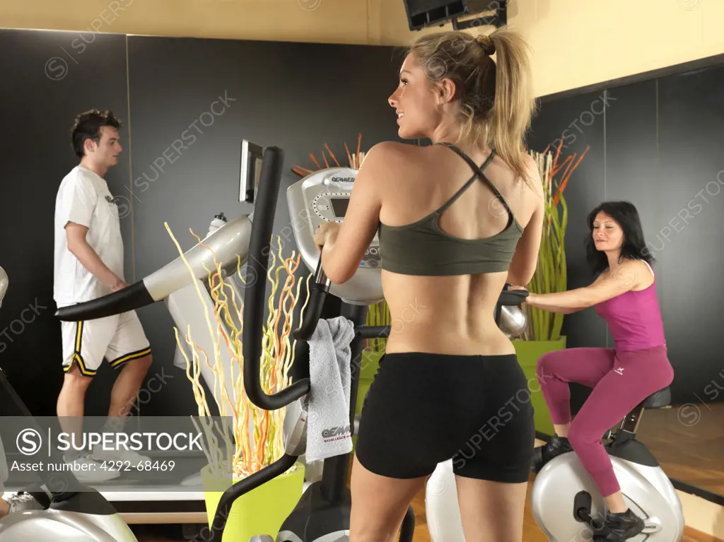 Close up of a group of people cycling on gym bikes