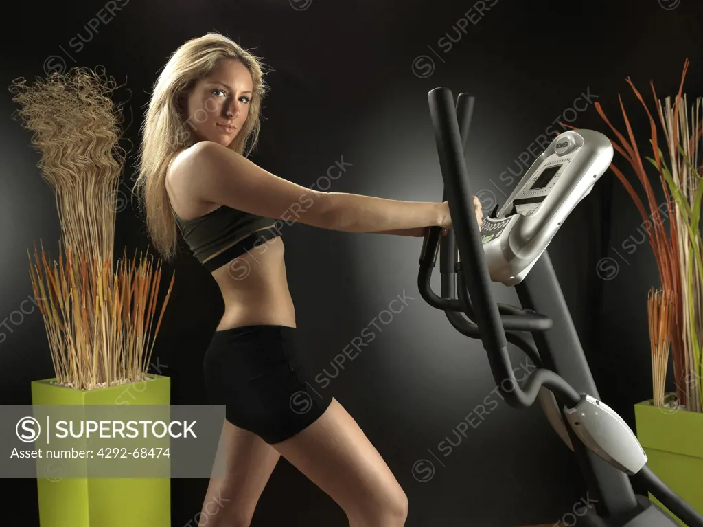 Woman at gym on exercise machine