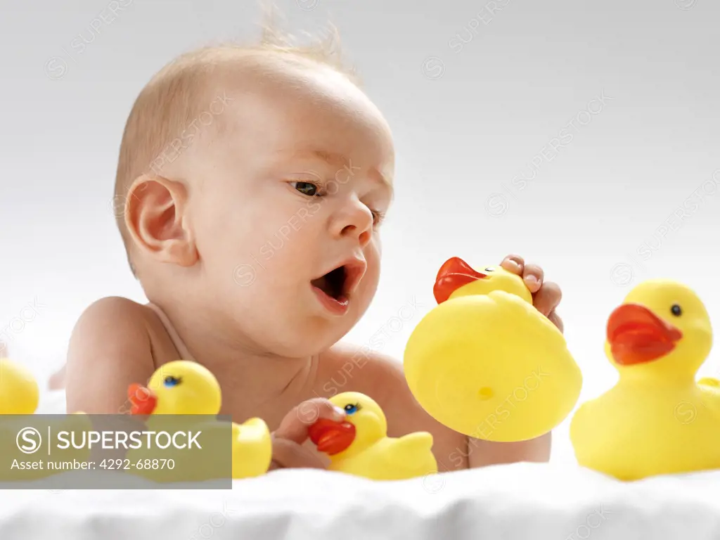 New born playing with rubber duck