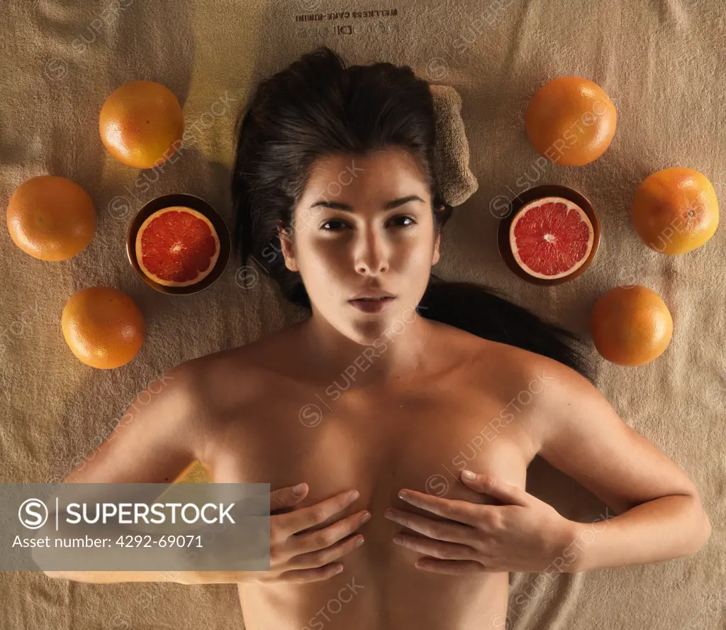 Woman having grapefruit massage in spa