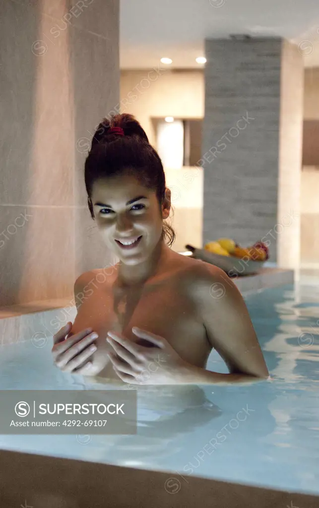 Woman relaxing in a thermal pool