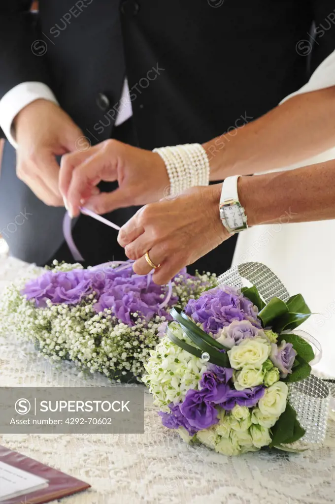 Wedding, bride placing ring on bride's finger