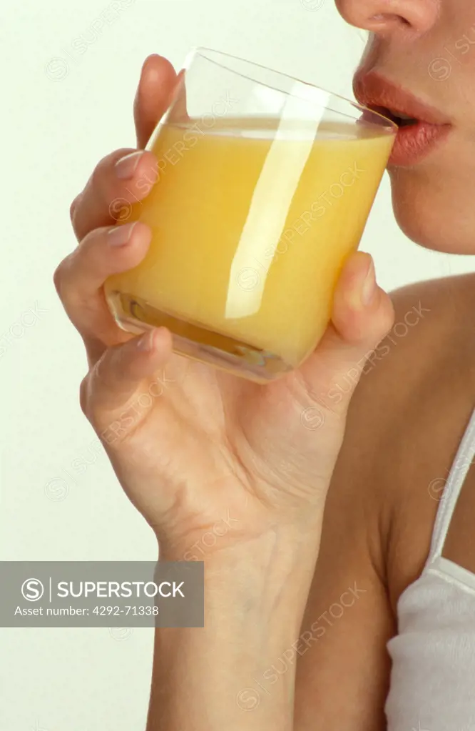 Woman drinking a glass of fruit juice