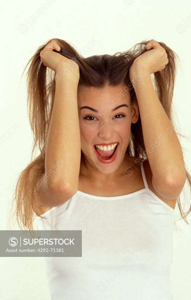 Young woman tearing hair out