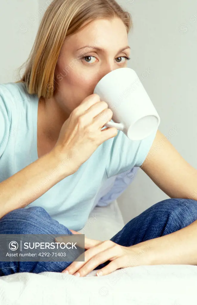 Young woman drinking from cup