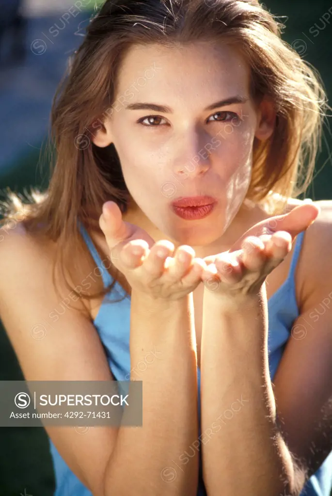 Woman blowing a kiss with hands