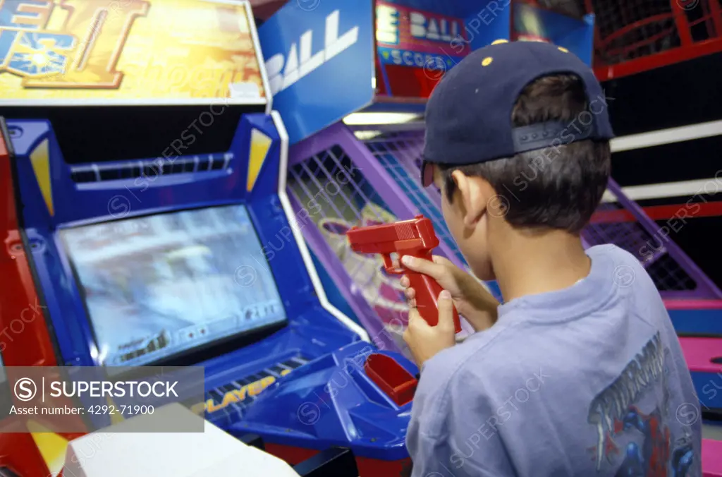 Child playing with videogame in arcade