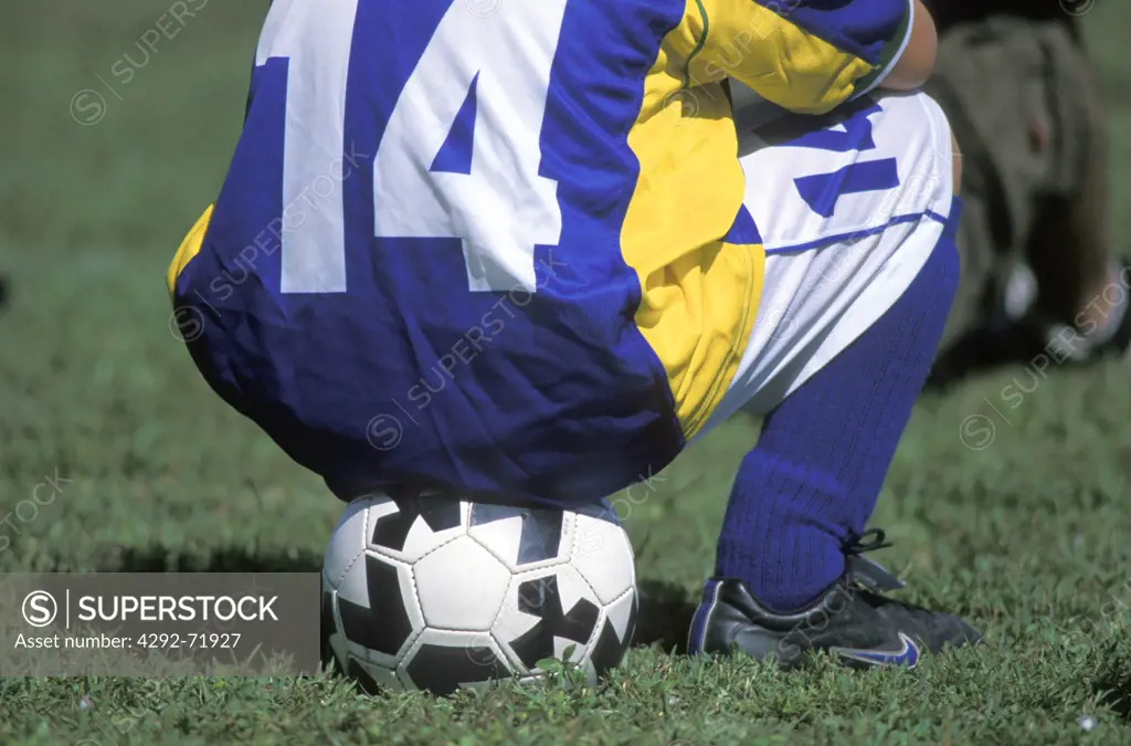 Footballer seat on the ball