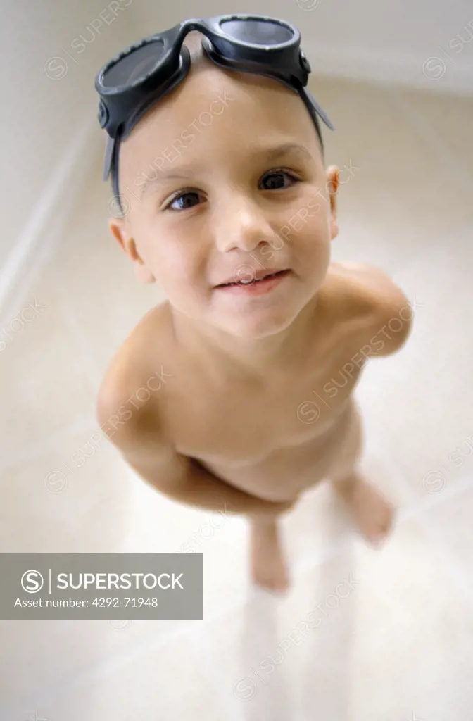 Naked boy with swimming goggles