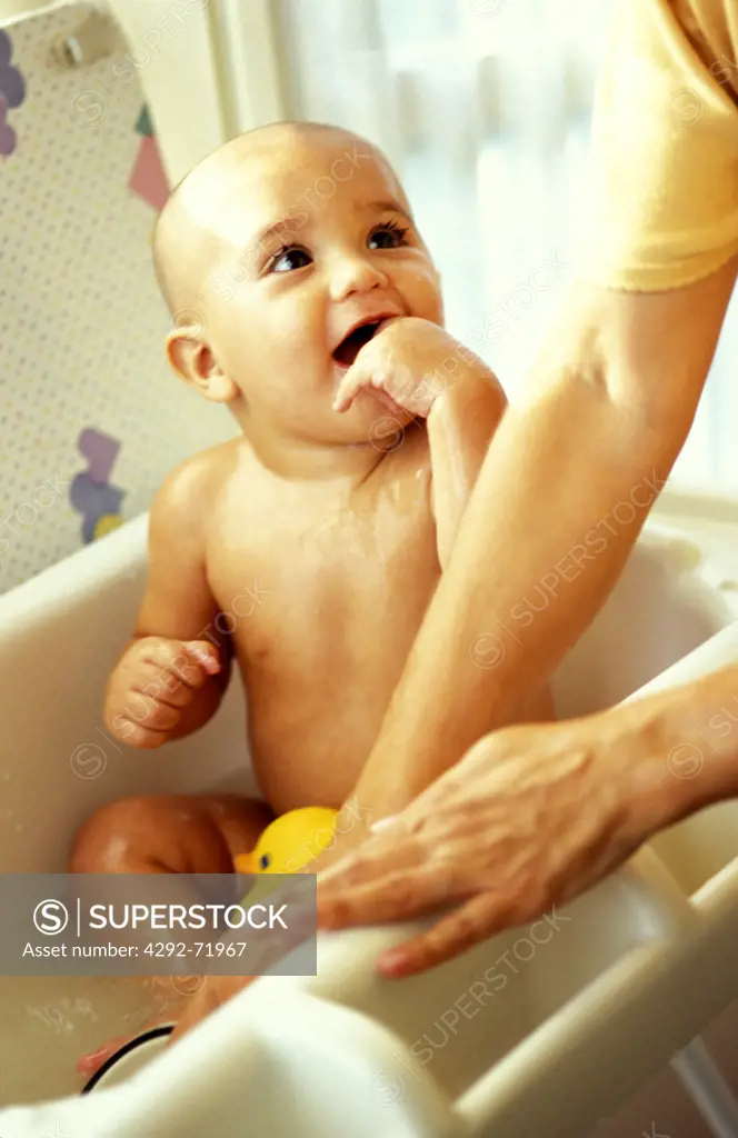 Mother washing baby