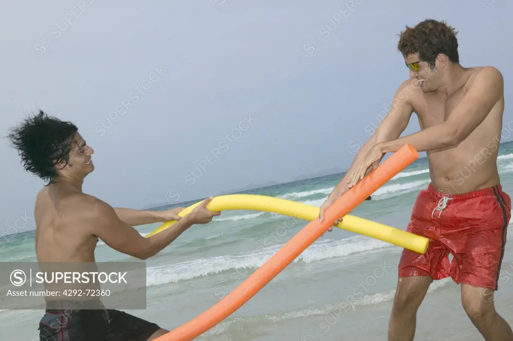 Men fighting with beach toys