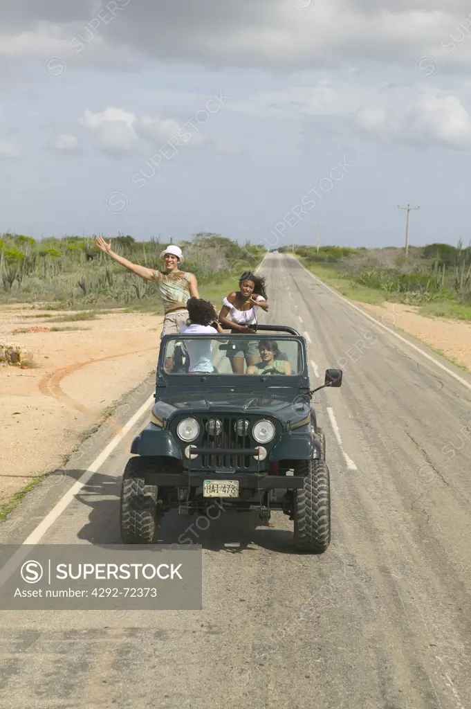 Group of friends in off road vehicle on the road