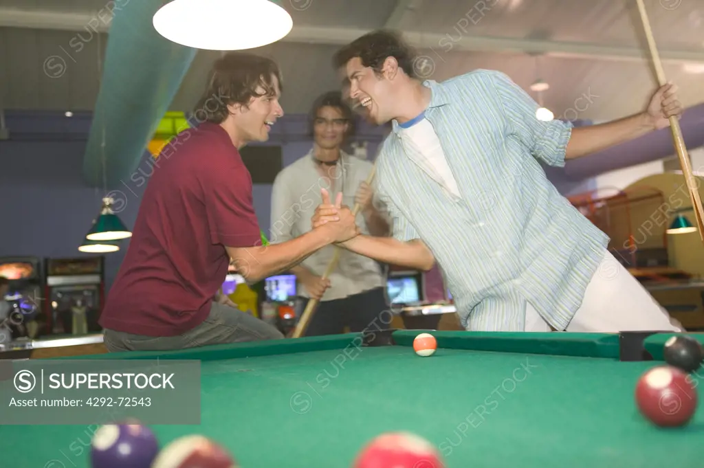 Young men playing billiard