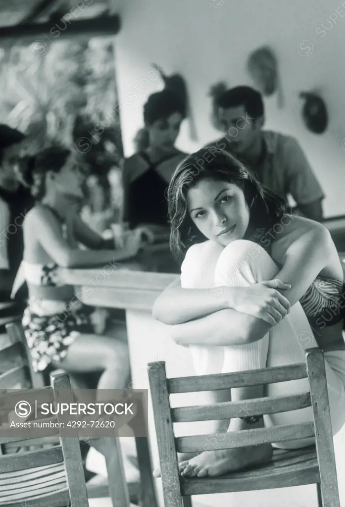 Pensive woman sitting in a cafe