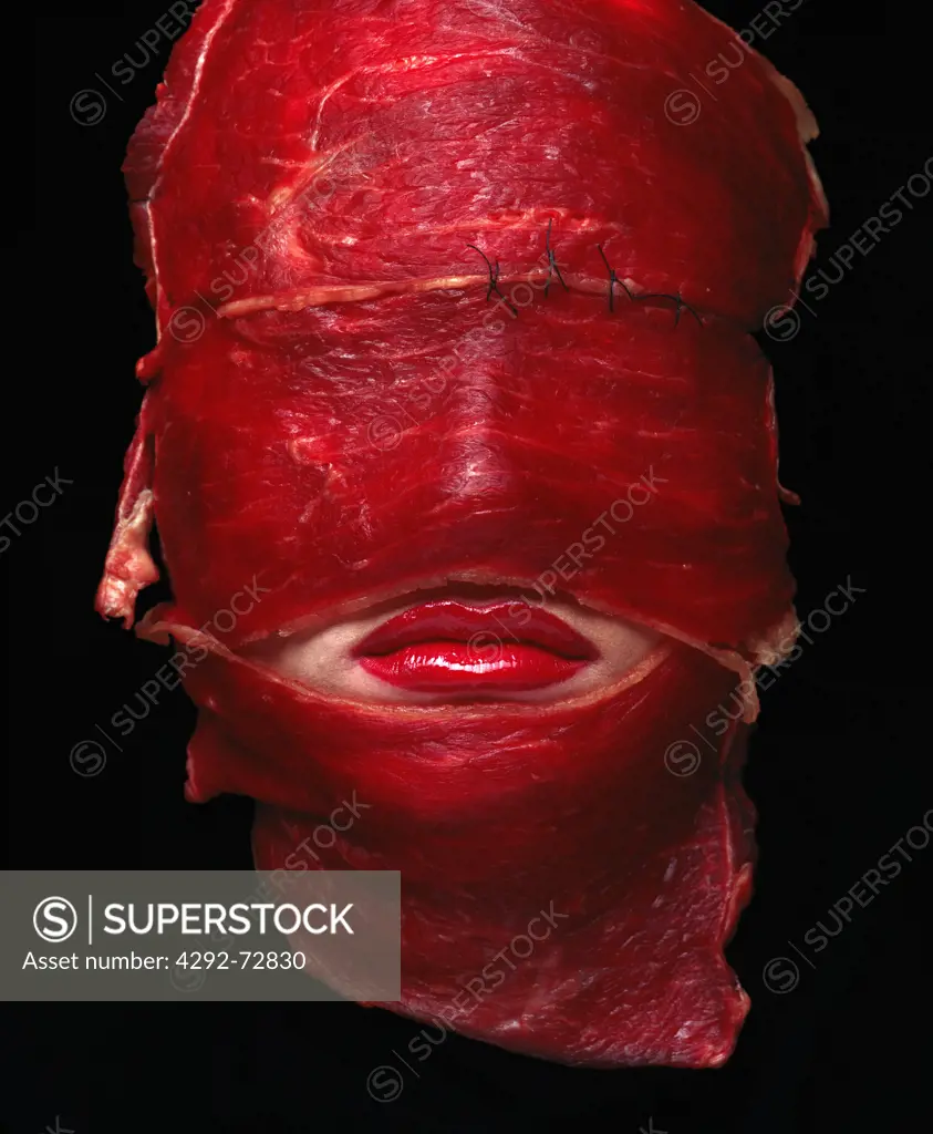 Woman's face covered with meat