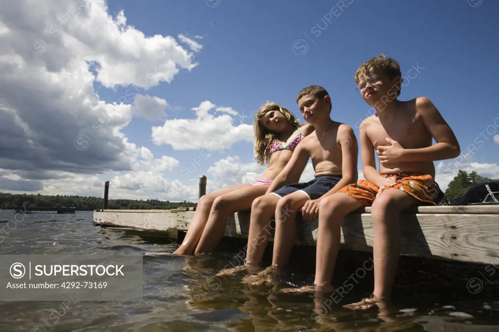 Group of young people sitting on jetty