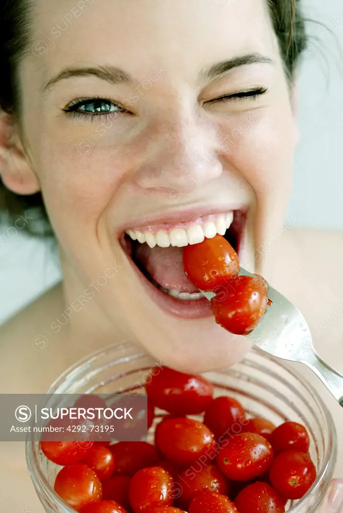 Woman eating cherry tomatoes