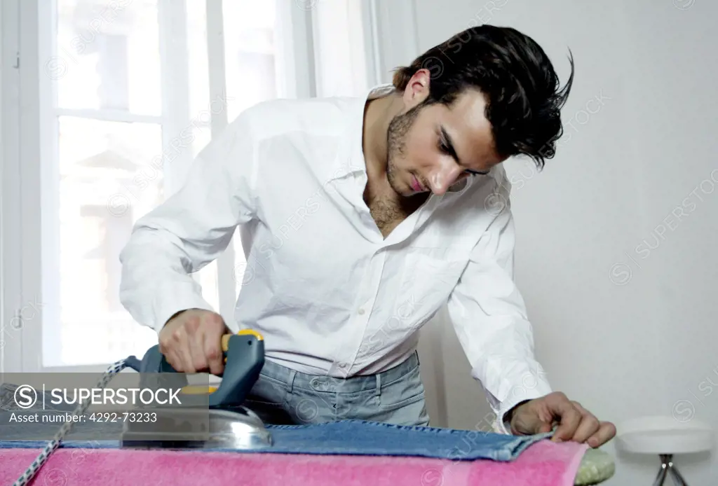 Man ironing jeans
